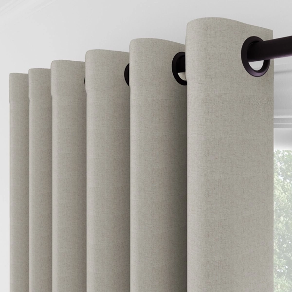 Close-up of beige grommet curtain pleats