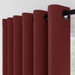 Close-up of burgundy eyelet curtain folds
