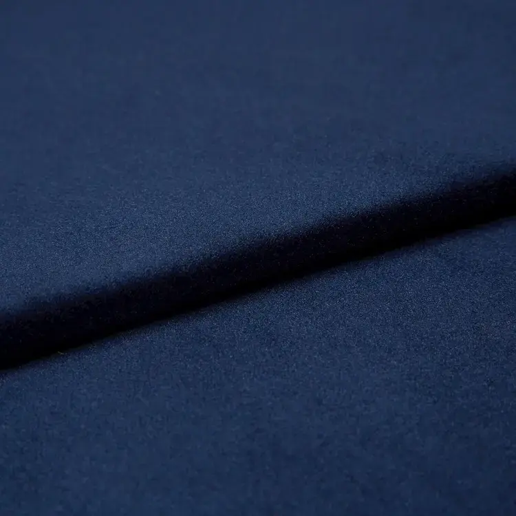Close-up of deep navy blue velvet fabric.