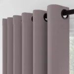 Close-up of mauve curtains with black grommets