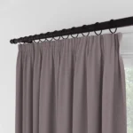 Close-up of mauve curtains with ring clips.