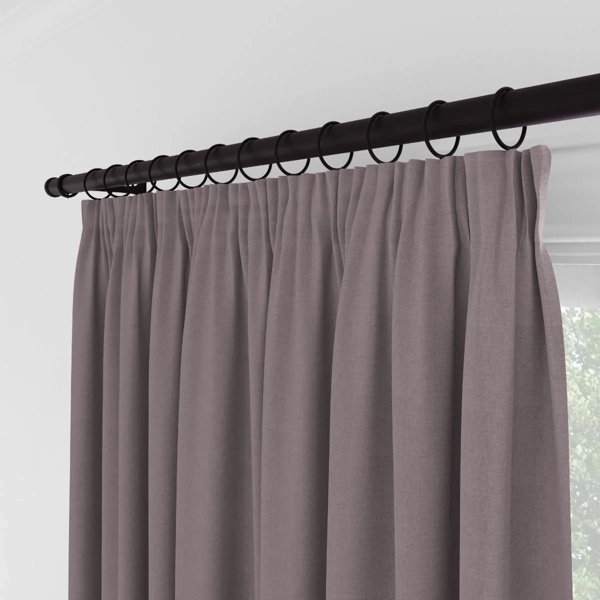 Close-up of mauve curtains with ring clips.
