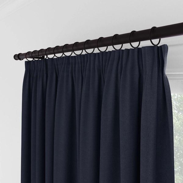 Close-up of navy curtains with ring clips