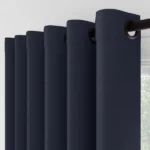 Close-up of navy grommet curtains and rod.
