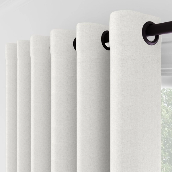 Close-up of white curtains with black grommets
