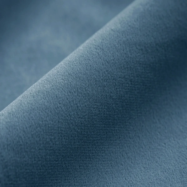 Detailed texture of plush Blue velvet fabric for curtains.
