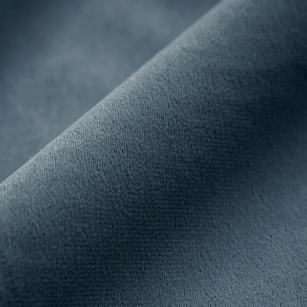 Detailed texture of plush navy blue velvet fabric for curtains.