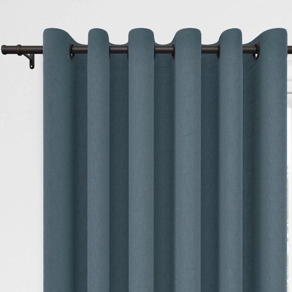 Dusty blue grommet curtains on a black rod