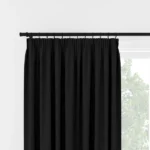 Front view of black pleated curtains on a rod