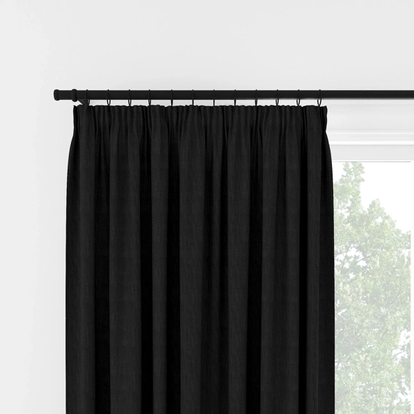 Front view of black pleated curtains on a rod