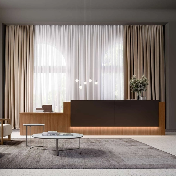 Layered tan and sheer white curtains behind a front desk.