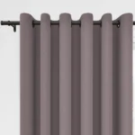 Mauve grommet curtains on a black rod