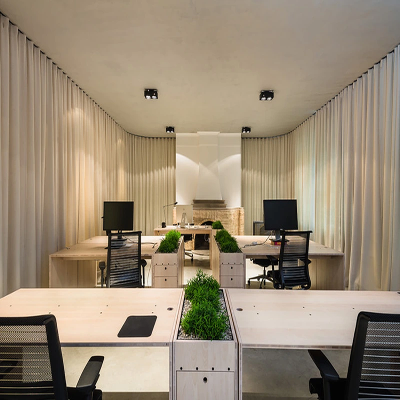 Modern open office with wood desks and white curtains