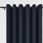 Navy blue grommet curtains on a dark rod