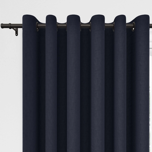 Navy blue grommet curtains on a dark rod