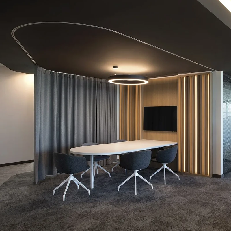Private meeting nook with curved track curtains.