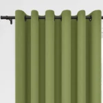 Sage green grommet curtains hanging on a dark rod