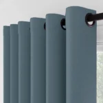 Side view of blue eyelet curtain folds.