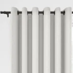 White grommet curtains on a black rod.